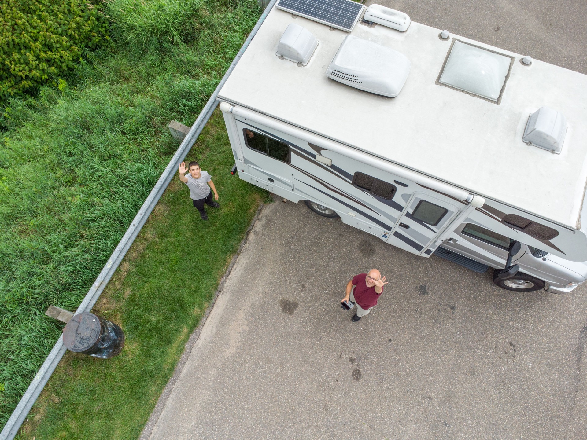 Aerial view of people besides motor home